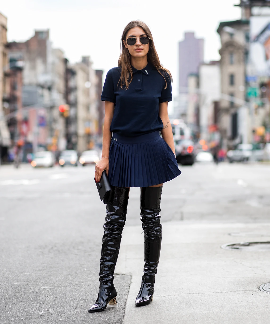 Woman wearing a navy Lacoste polo outfit